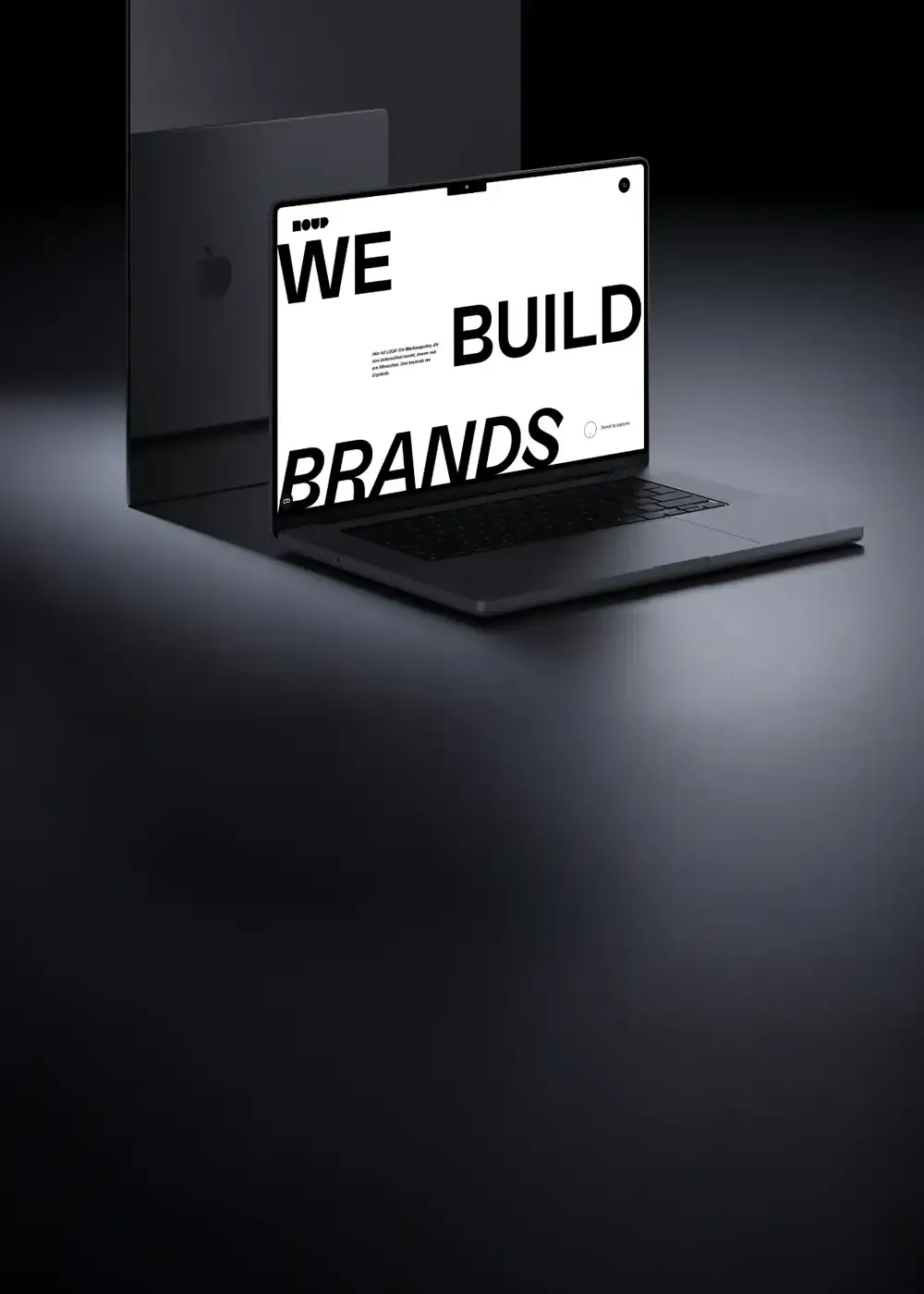 Laptop mit dem Homepage Screen dieser Website und dem Text We build brands in einem dunklen, wertigen Setting